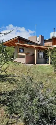 a house sitting on top of a grass field at Mirador de baco in Santa Rosa de Calamuchita