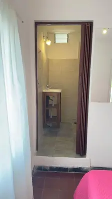 a bathroom with a shower with a sink and a mirror at Habitación con baño zona cucú 2 personas in Villa Carlos Paz