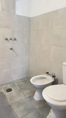 a bathroom with a white toilet and a shower at Habitación con baño zona cucú 2 personas in Villa Carlos Paz