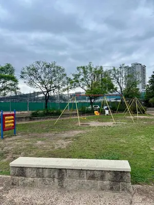 a park with two swings in the grass at Departamento para dos personas VILLA SOL in Cordoba