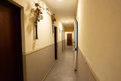 a hallway with a long corridor with plants on the walls at Hosteria Cruz del Sur in Villa Carlos Paz