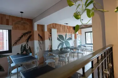 a row of tables and chairs in a restaurant at Hosteria Cruz del Sur in Villa Carlos Paz