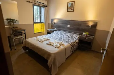 a bedroom with a bed with two white bows on it at Hosteria Cruz del Sur in Villa Carlos Paz