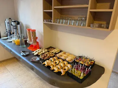 a table with different types of pastries on it at Hosteria Cruz del Sur in Villa Carlos Paz