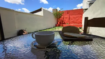 a cup of coffee sitting on top of a table at Espacio Inn zona Kempes in Cordoba