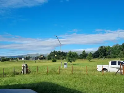 a white truck parked in a field with a street light at Casa Los Reartes in Villa General Belgrano