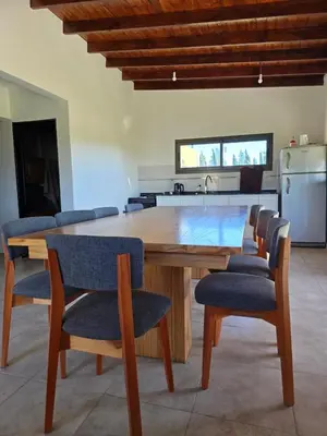 a kitchen with a wooden table and chairs at Casa Los Reartes in Villa General Belgrano