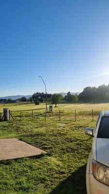 a car parked next to a field with a street light at Casa Los Reartes in Villa General Belgrano