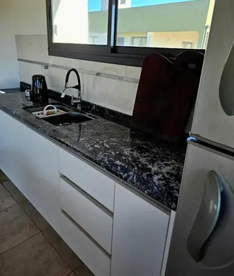 a kitchen counter with a sink and a window at Casa Los Reartes in Villa General Belgrano