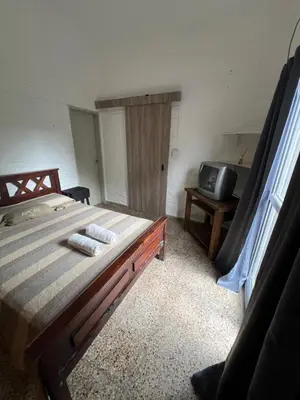 a bedroom with a large bed and a television at Depto 168 in Santa Rosa de Calamuchita