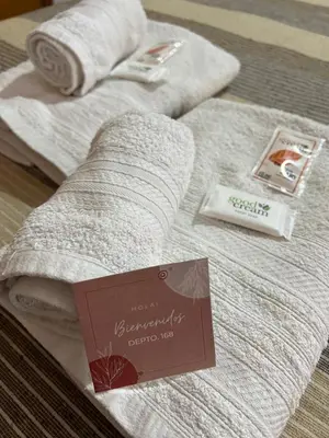 a couple of towels sitting on top of a bed at Depto 168 in Santa Rosa de Calamuchita