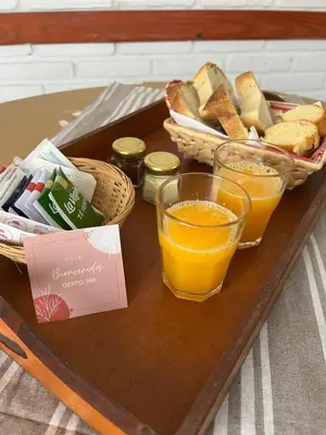 a tray with bread and orange juice and toast at Depto 168 in Santa Rosa de Calamuchita