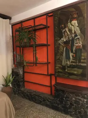 a large red door with a painting on it at Alta Casa in Cordoba