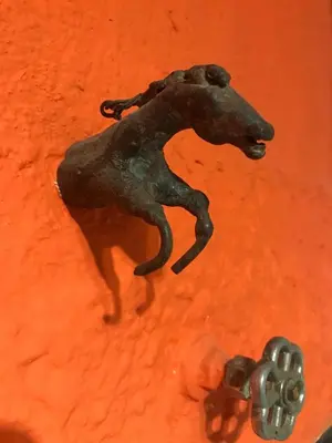 a statue of a horse on an orange background at Alta Casa in Cordoba