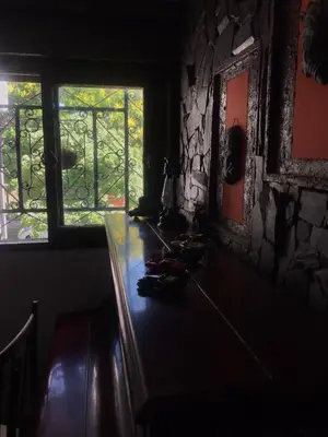 a dark room with a table and a window at Alta Casa in Cordoba