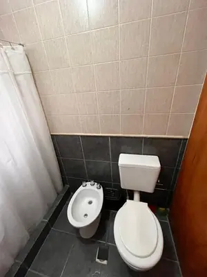a small bathroom with a toilet and a bidet at Cabañas Don Lelio 2 in Mina Clavero