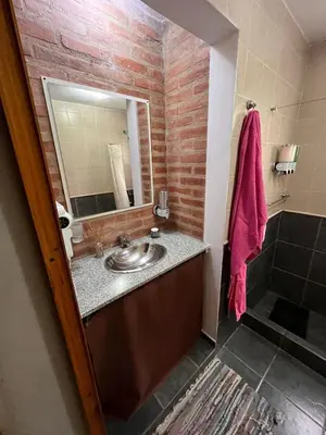 a bathroom with a sink and a mirror at Cabañas Don Lelio 2 in Mina Clavero