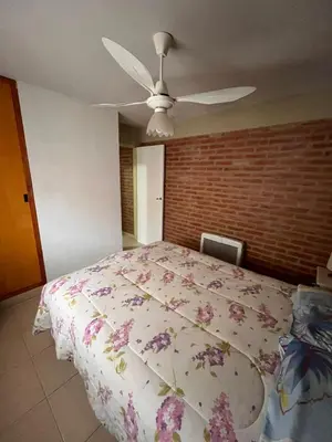 a bedroom with a bed and a ceiling fan at Cabañas Don Lelio 2 in Mina Clavero