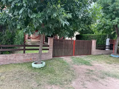 a tree in a pot next to a fence at Cabañas Don Lelio 2 in Mina Clavero