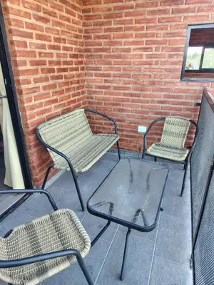 three chairs and a table on a patio at Panorámica Sierras in Villa Carlos Paz