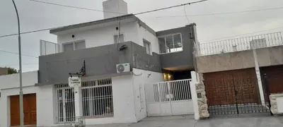 a white building with a gate in front of it at calido descanso in Rio Cuarto