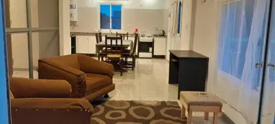 a living room with a couch and a dining room at calido descanso in Rio Cuarto