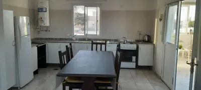 a kitchen with a table and a table and chairs at calido descanso in Rio Cuarto