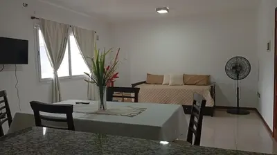 a living room with a table and a bed at Apartamento villa Carlos Paz in Villa Carlos Paz