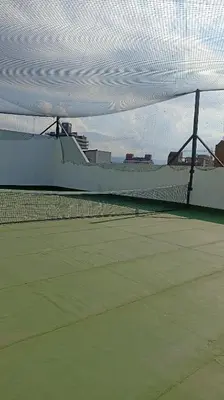 a tennis court with a net on a tennis court at Apartamento villa Carlos Paz in Villa Carlos Paz