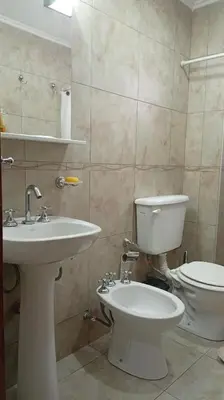 a bathroom with a toilet and a sink at Apartamento villa Carlos Paz in Villa Carlos Paz