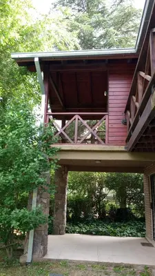 a house with a bridge over a walk way at Abedules VGB in Villa General Belgrano