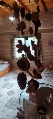 a group of hats hanging from the ceiling of a bedroom at CASA QUINTA en ESTANCIA VIEJA in Villa Carlos Paz