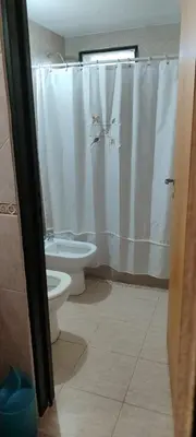 a bathroom with a toilet and a shower curtain at CASA QUINTA en ESTANCIA VIEJA in Villa Carlos Paz