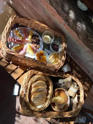 two baskets of bread and pastries on a table at Reserva Ichacuna in Los Hornillos