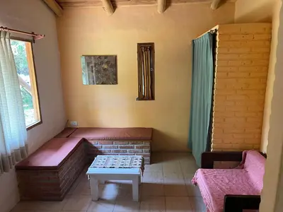 a room with a couch and a table in a room at Reserva Ichacuna in Los Hornillos