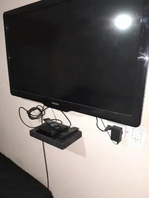 a flat screen television with a remote control on a stand at casa para 10 exc ubicacion garage 3 autos in Cordoba