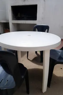 a white table with two chairs and a table with two chairs at casa para 10 exc ubicacion garage 3 autos in Cordoba