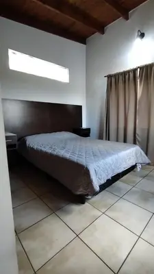 a bedroom with a large bed in a room at EL REFUGIO DE MERLO, alquiler temporario in Merlo