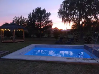a swimming pool in a yard with a gazebo at EL REFUGIO DE MERLO, alquiler temporario in Merlo