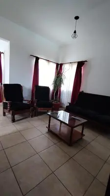a living room with couches and a coffee table at EL REFUGIO DE MERLO, alquiler temporario in Merlo