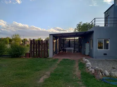 a house with a garage and a fence at EL REFUGIO DE MERLO, alquiler temporario in Merlo