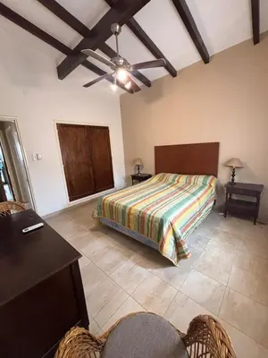 a bedroom with a bed and a table and chairs at Casa Paz in Villa Carlos Paz