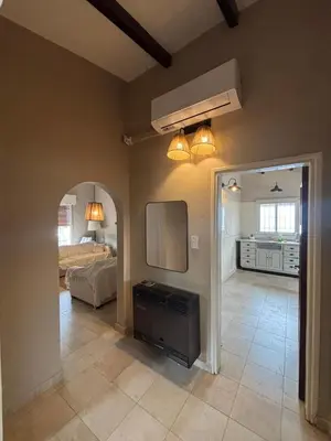 a living room with a television and a bedroom at Casa Paz in Villa Carlos Paz