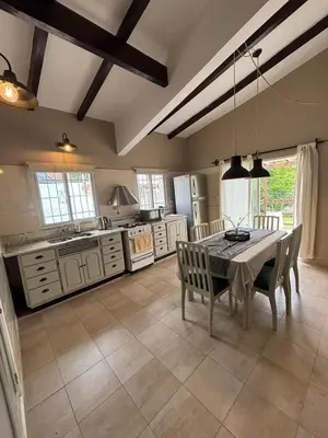 a kitchen with a table and chairs in a room at Casa Paz in Villa Carlos Paz