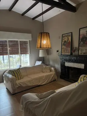 a living room with a couch and a fireplace at Casa Paz in Villa Carlos Paz