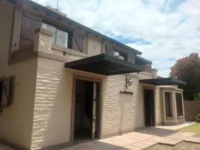 a house with a balcony on top of it at Departamento Matrimonial Merlo San luis in Merlo