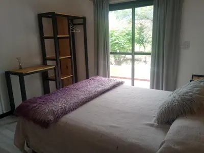 a bedroom with a bed and a book shelf and a window at Departamento Matrimonial Merlo San luis in Merlo