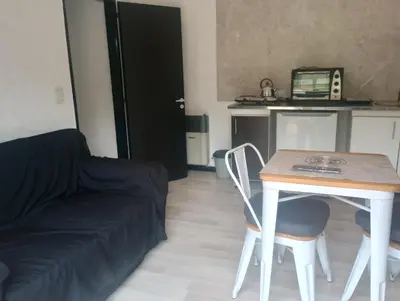a living room with a table and a couch at Departamento Matrimonial Merlo San luis in Merlo
