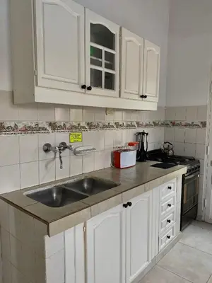a kitchen with white cabinets and a sink at Departamento Matrimonial Merlo San luis in Merlo