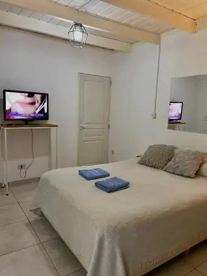 a bedroom with a bed with two blue towels on it at Departamento Matrimonial Merlo San luis in Merlo